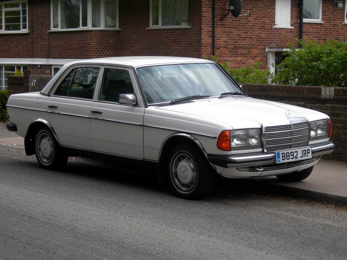 Classic sedan front and side view with rectangular headlights and chrome grille