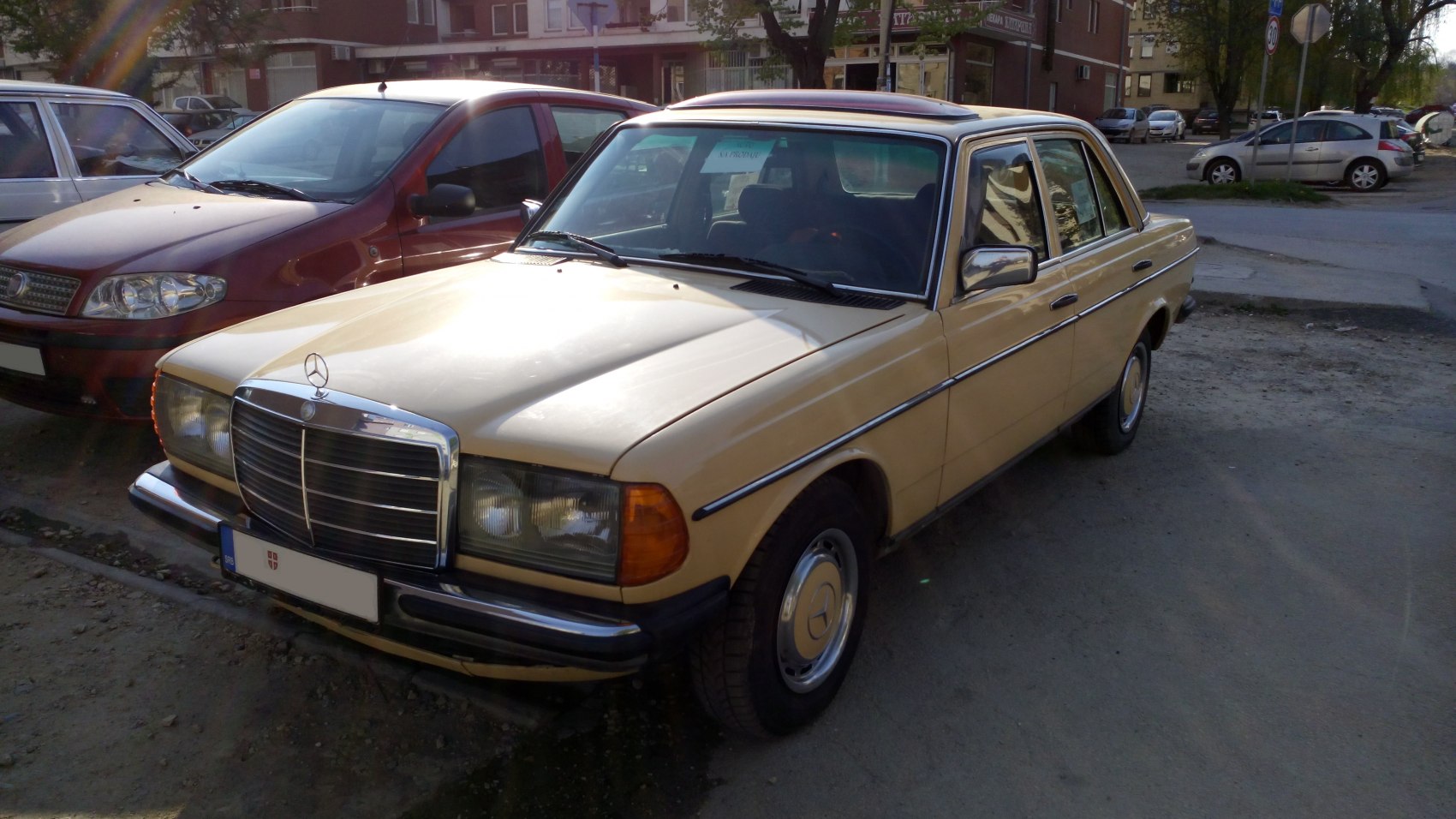 Beige vintage sedan with chrome grille and roof sunroof