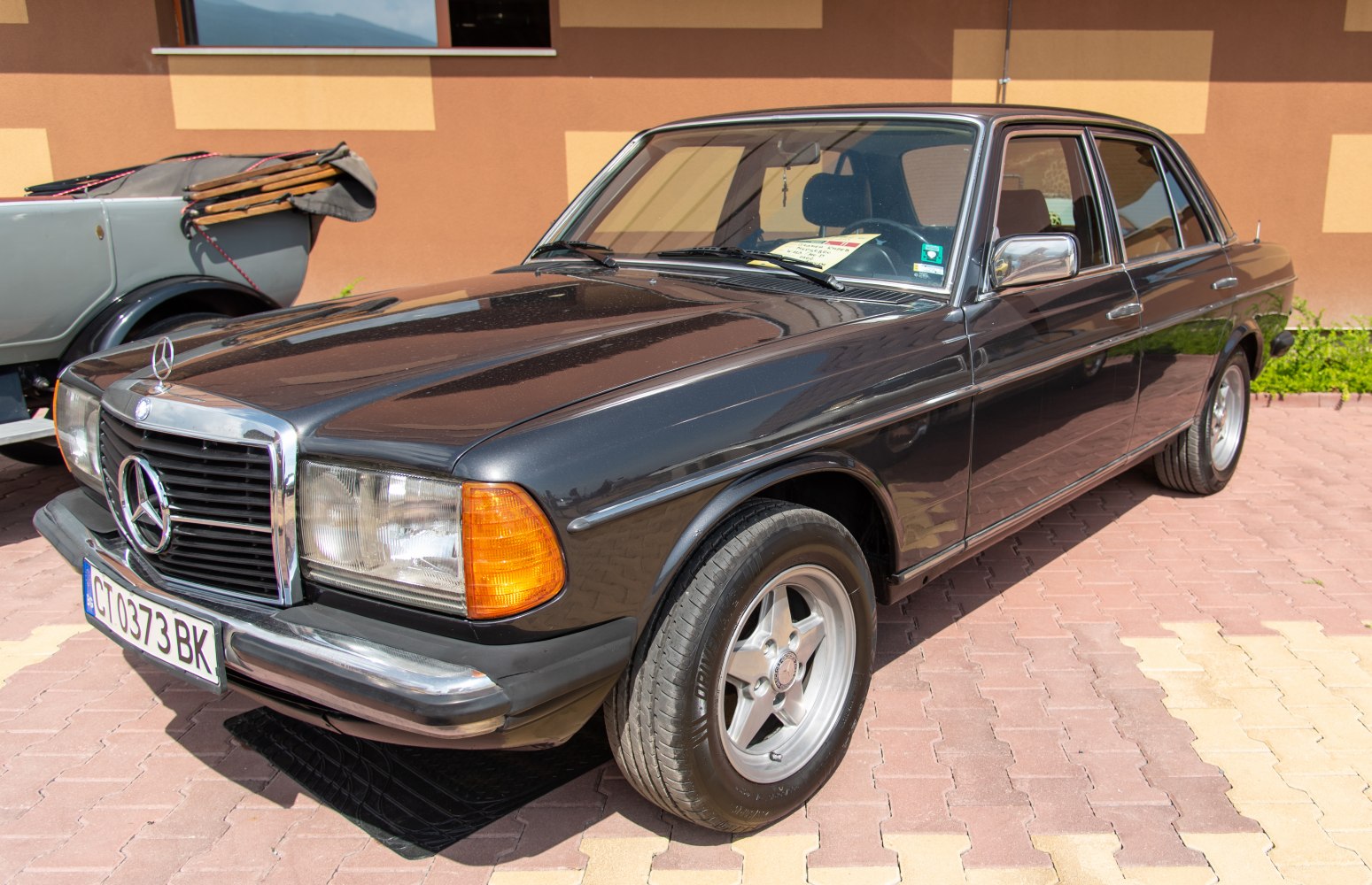 Classic vintage sedan with prominent front grille and side profile.