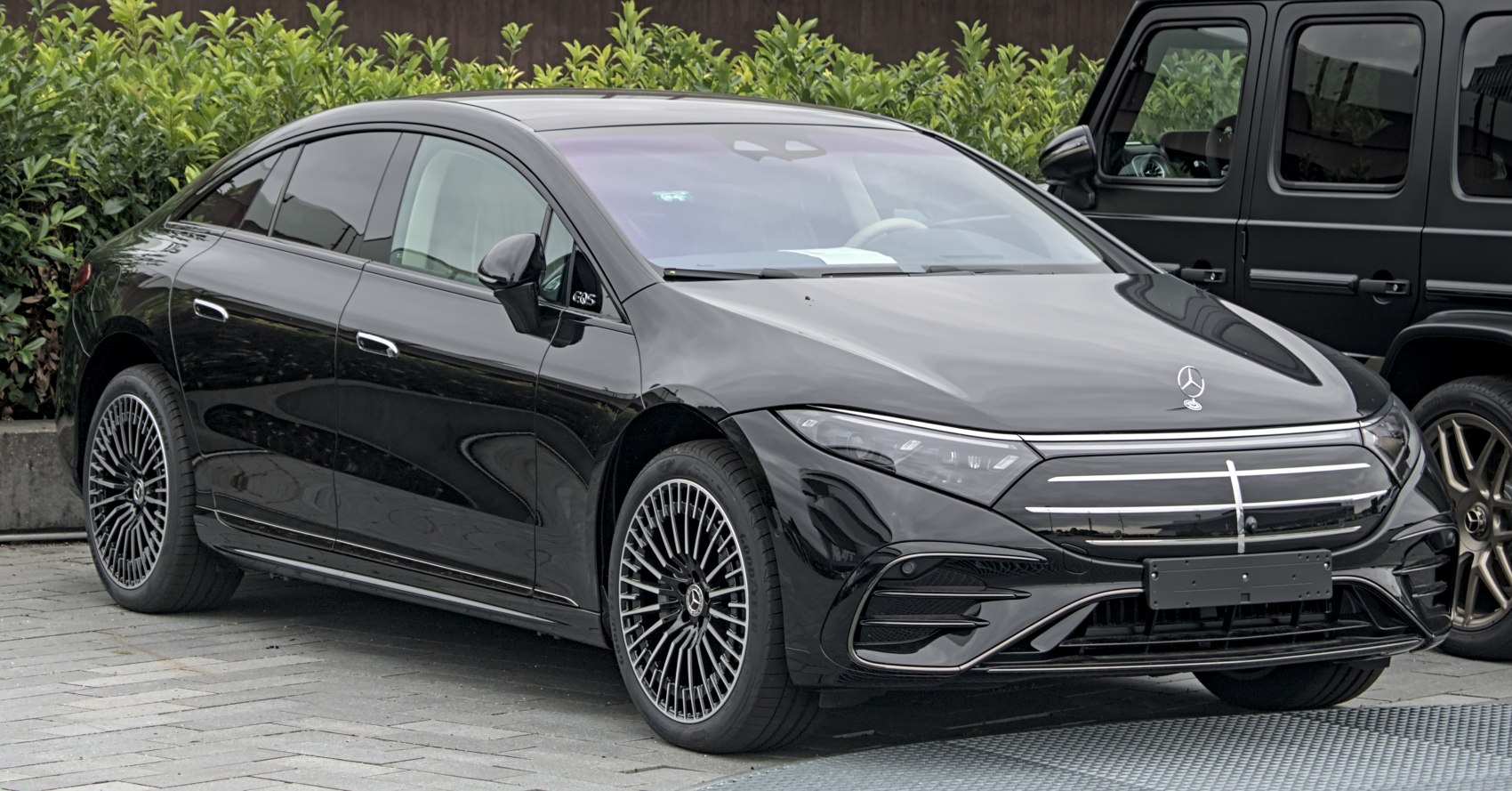 Luxury electric sedan with LED headlights and aerodynamic multi-spoke alloy wheels