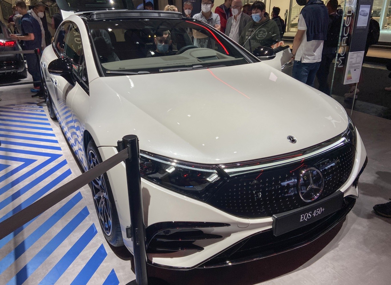 Front view of luxury electric sedan with LED headlamps and sleek grille