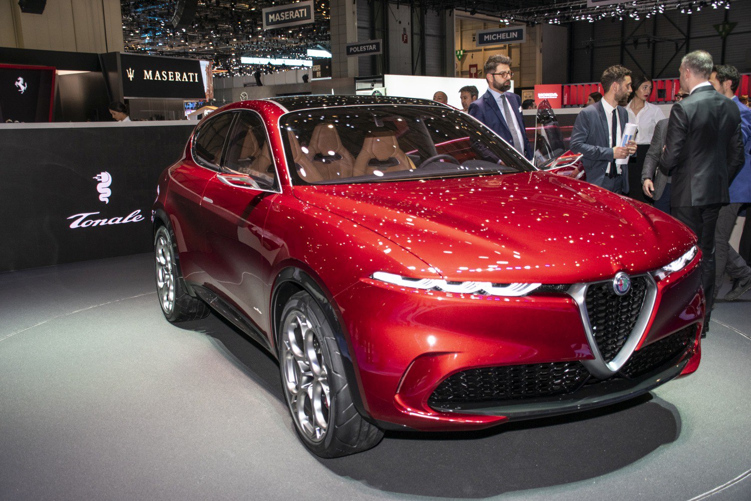 Sleek red crossover with futuristic narrow LED headlights and sporty wheels