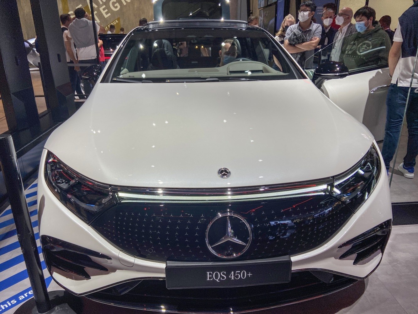 Front view of luxury electric sedan with LED headlights and sleek grille