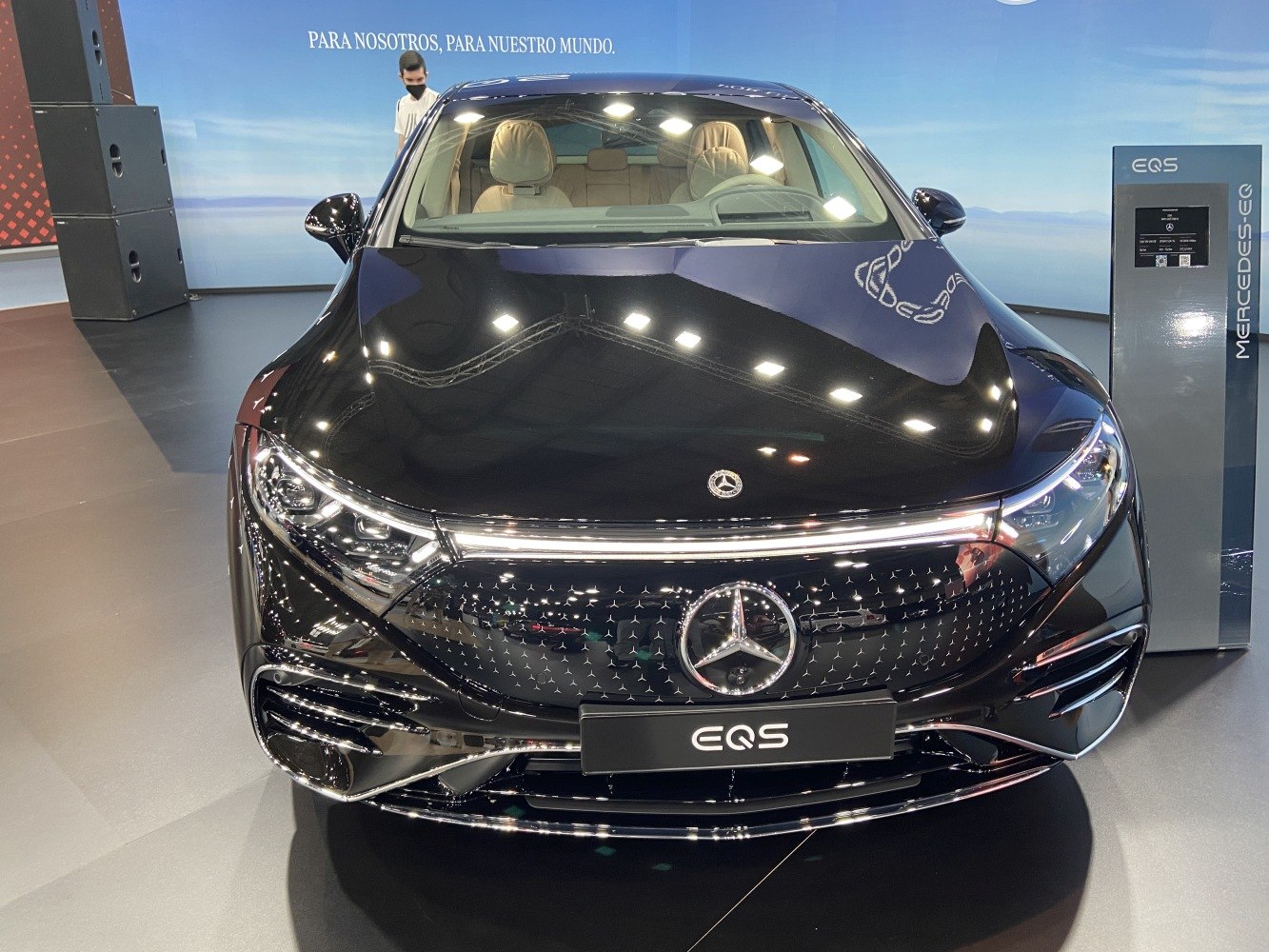 Front view of sleek electric luxury sedan with LED headlights and detailed grille.