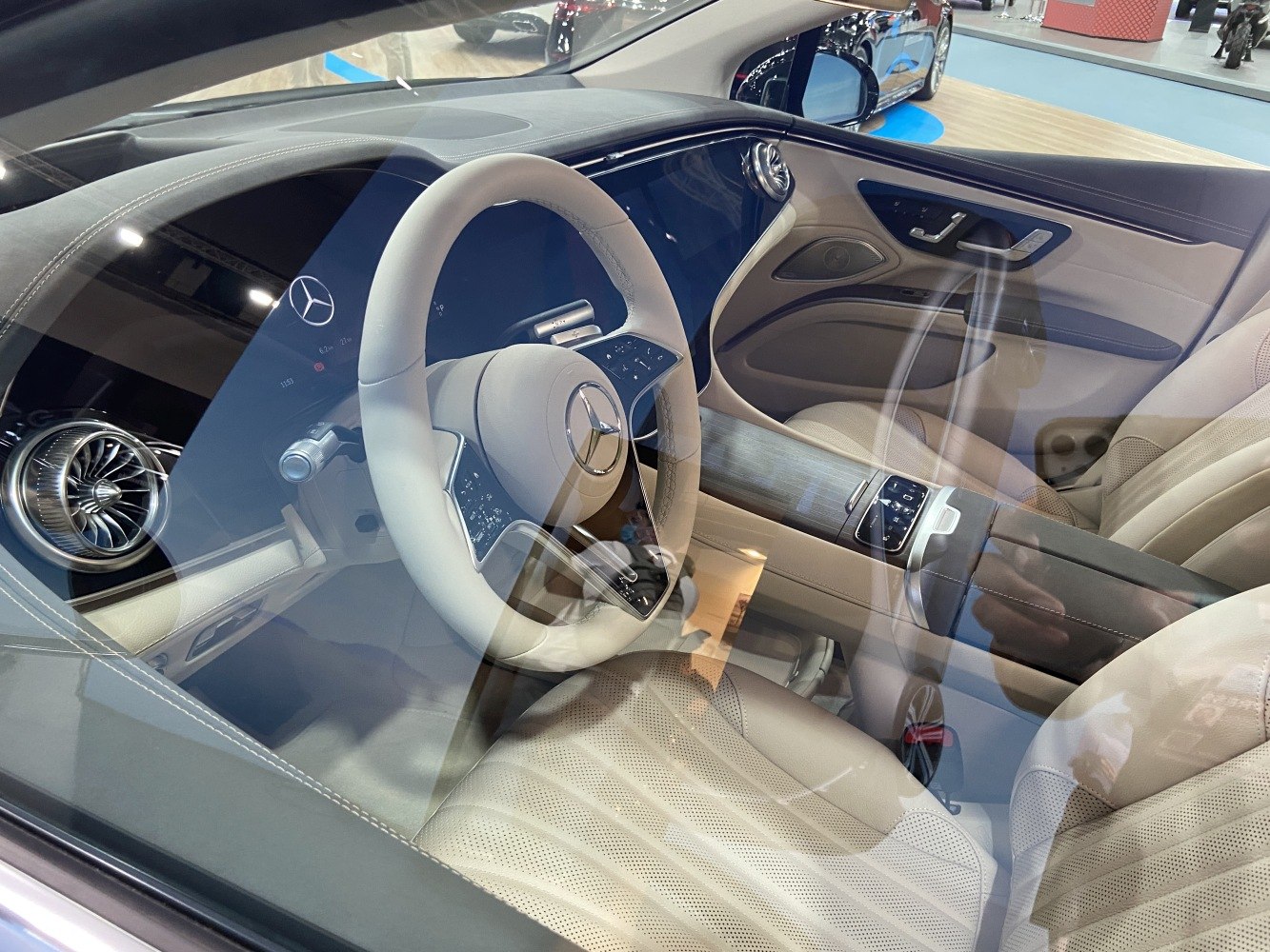 Beige leather interior with digital dashboard and steering wheel