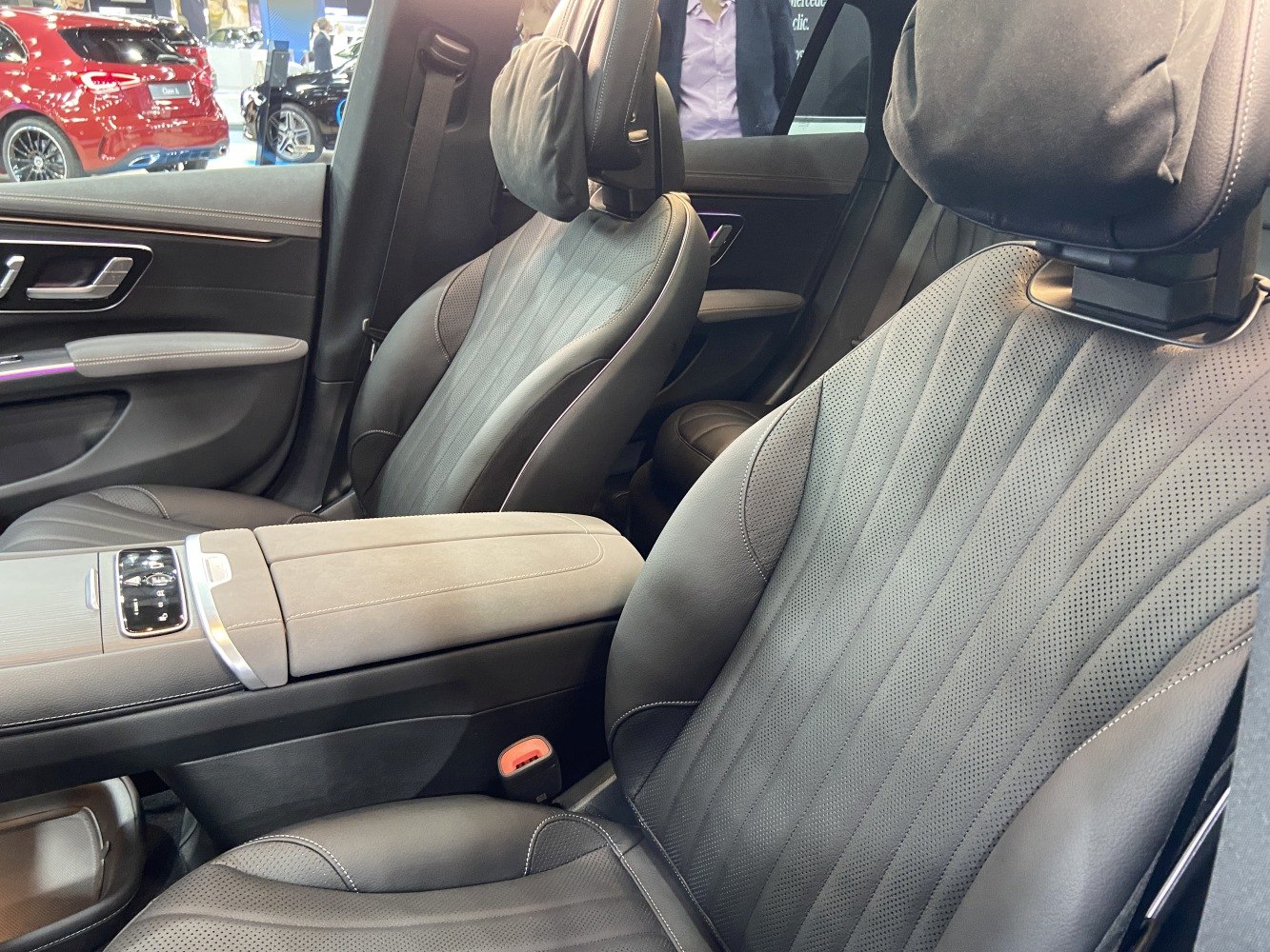 Close-up of perforated leather front seats and center armrest