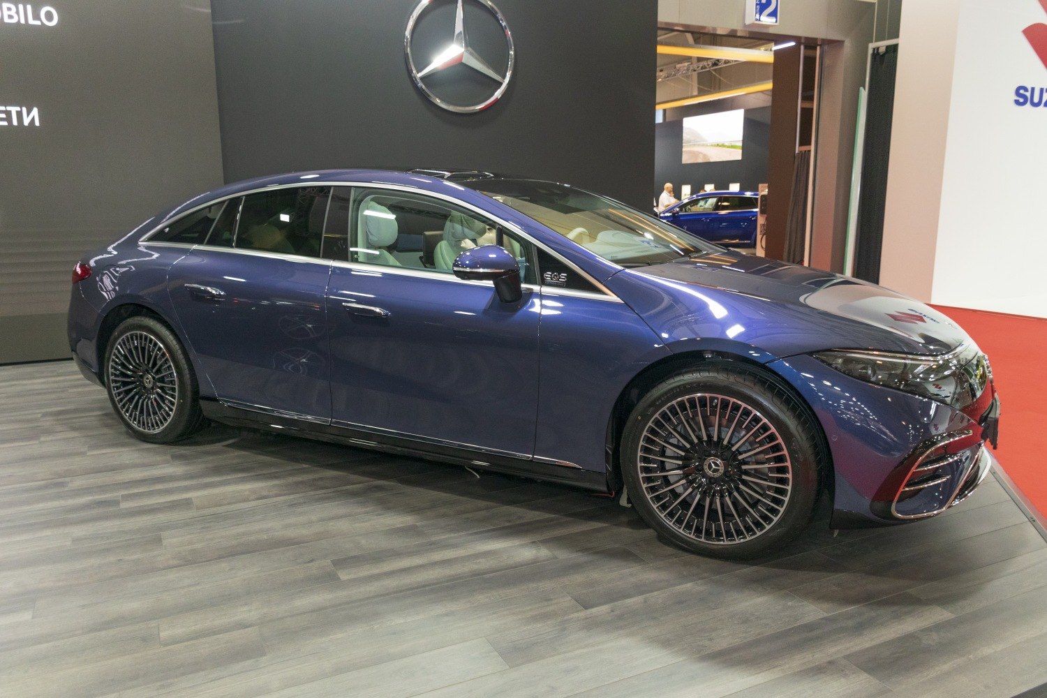 Luxury electric sedan with sleek aerodynamic profile and multi-spoke wheels