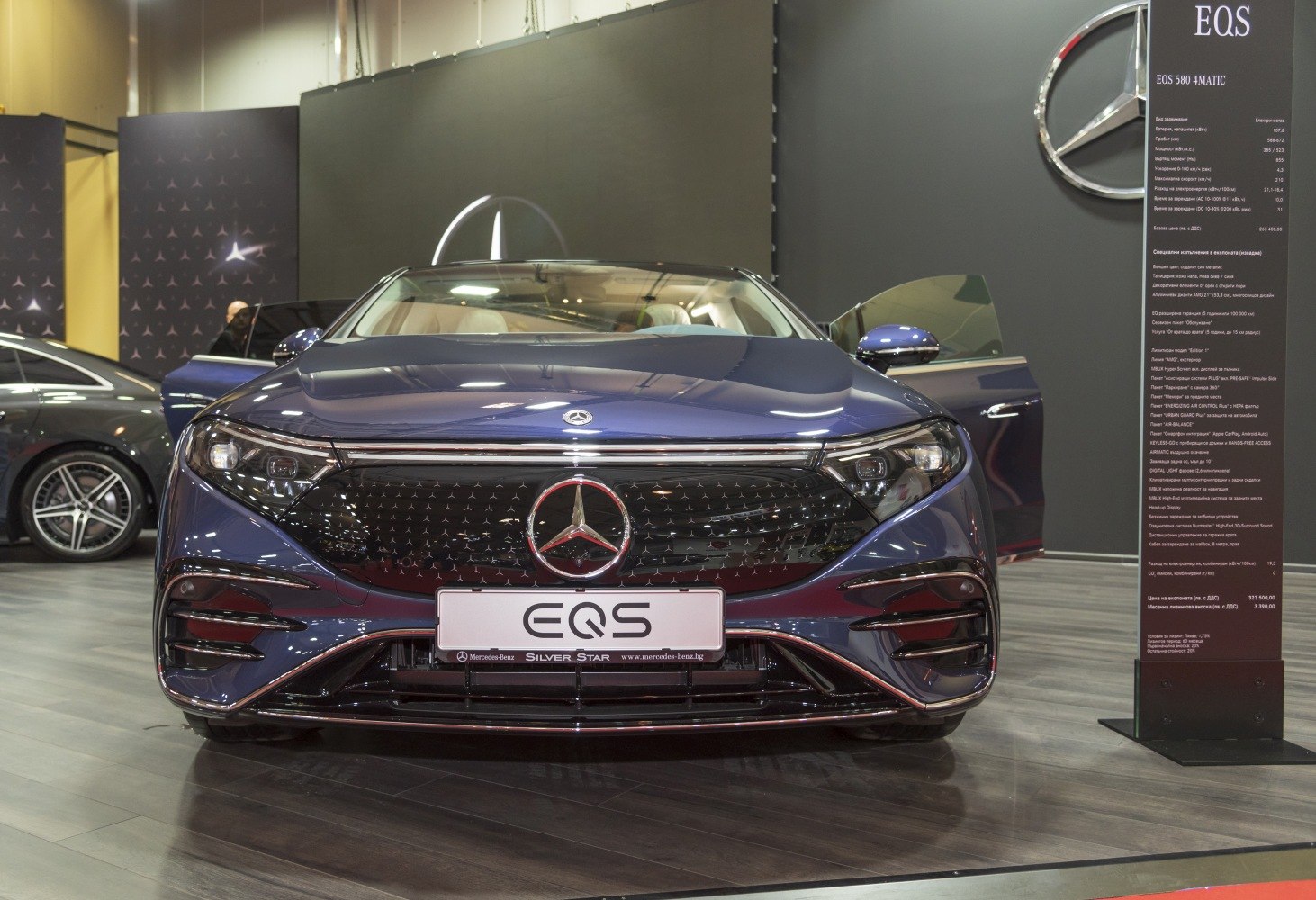 Sleek luxury sedan front with LED-lit grille and aerodynamic design