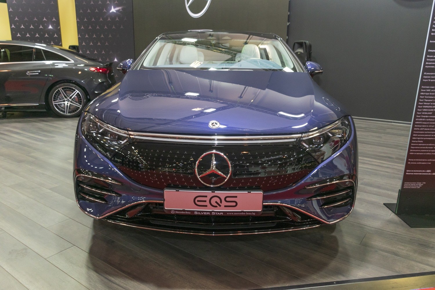 Front view of electric luxury sedan with distinctive grille and LED headlights