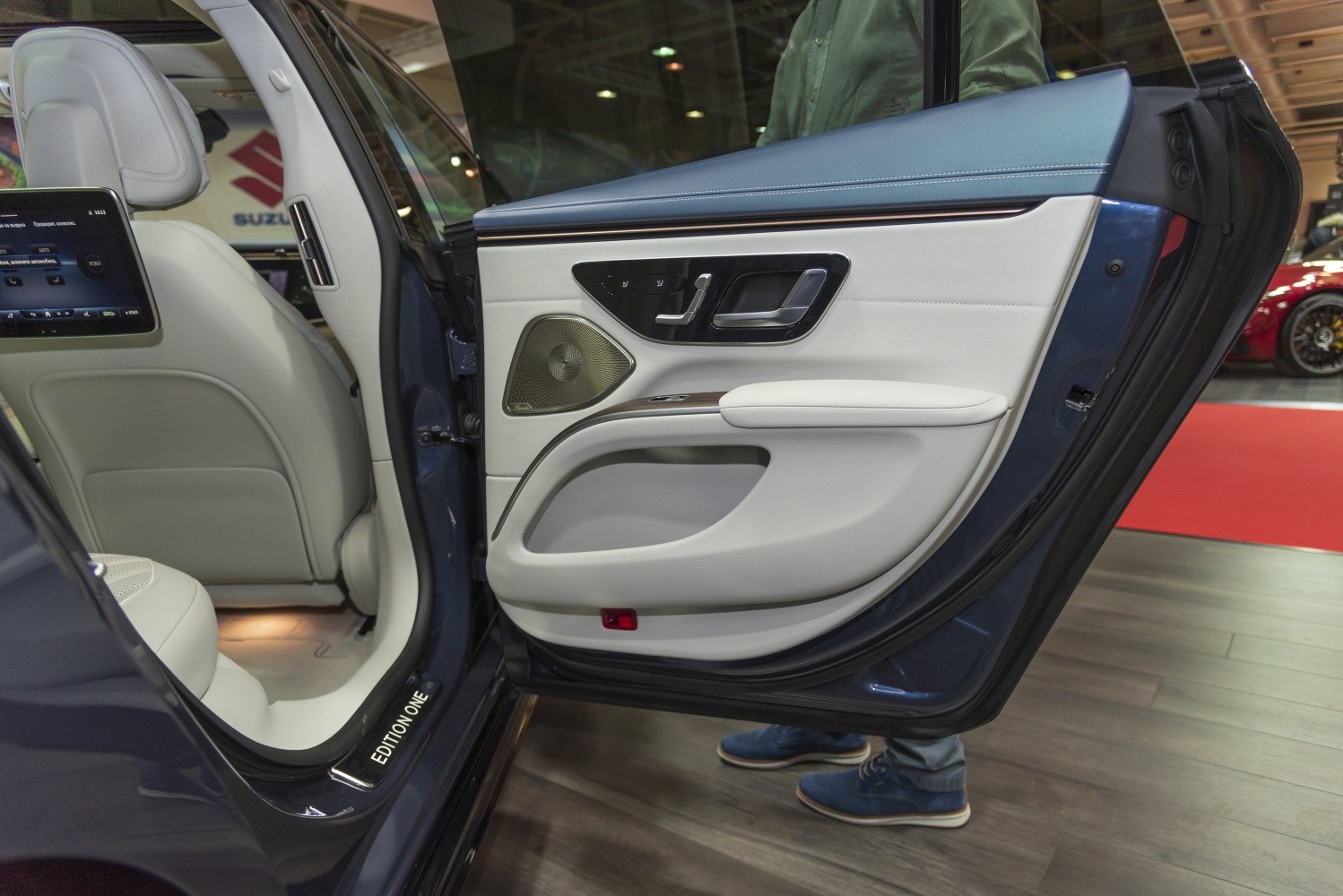 Rear door interior panel with seat controls and white leather seat