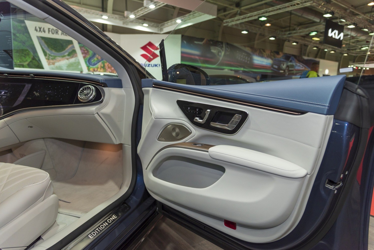 Luxury electric sedan door panel with advanced seat controls and premium materials