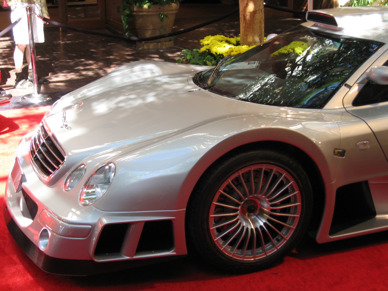 Front side view of sleek sports coupe with aerodynamic body and detailed alloy wheels