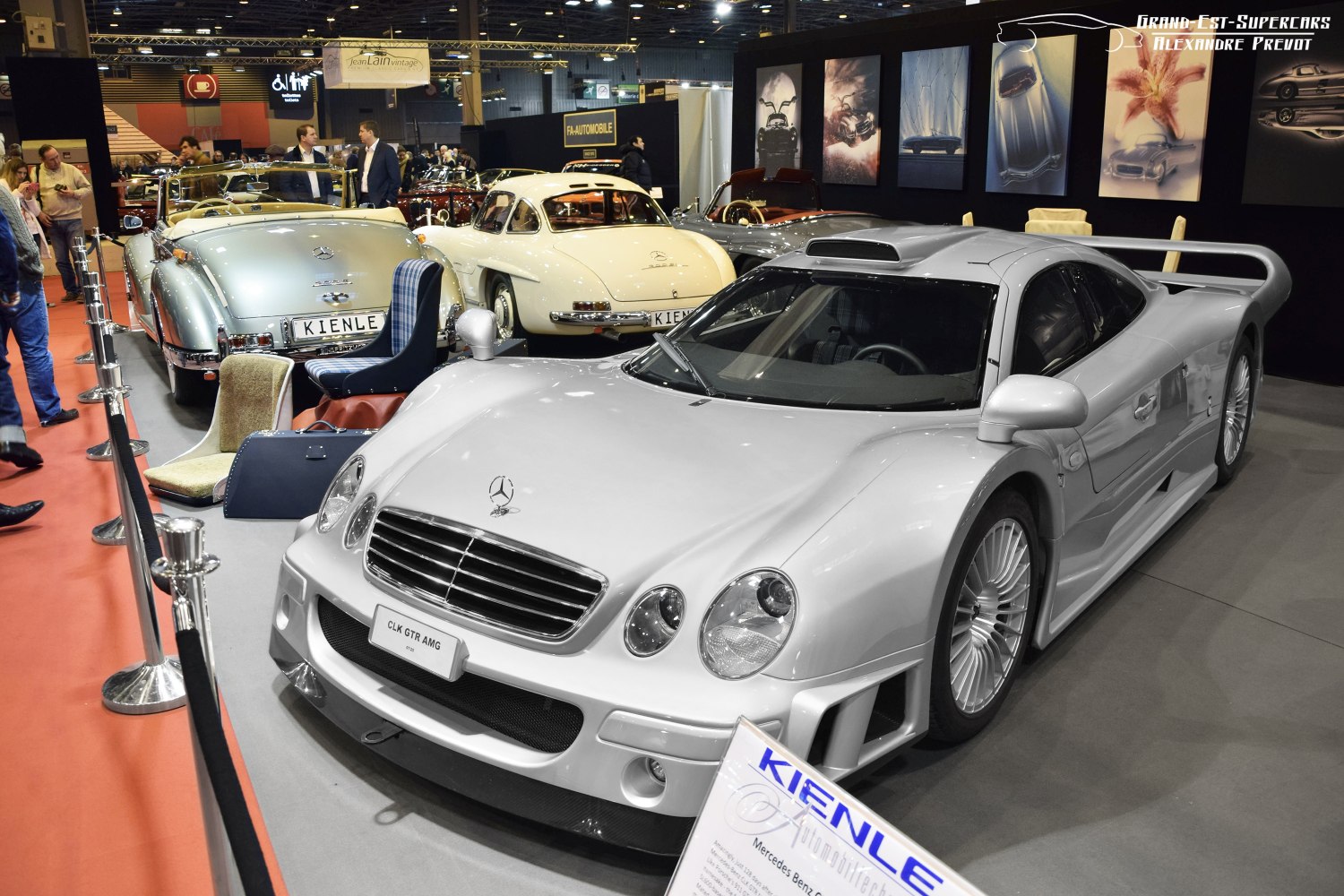 Silver aerodynamic supercar with prominent front grille and large rear spoiler