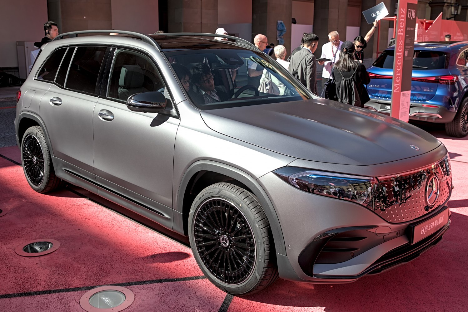 Front and side view of matte-finish electric SUV with distinctive grille and black alloy wheels
