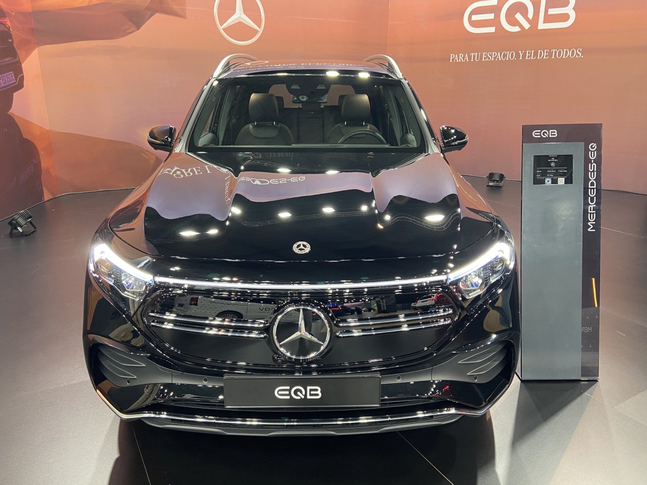 Close-up front view of sleek luxury electric SUV with distinctive grille and LED headlights