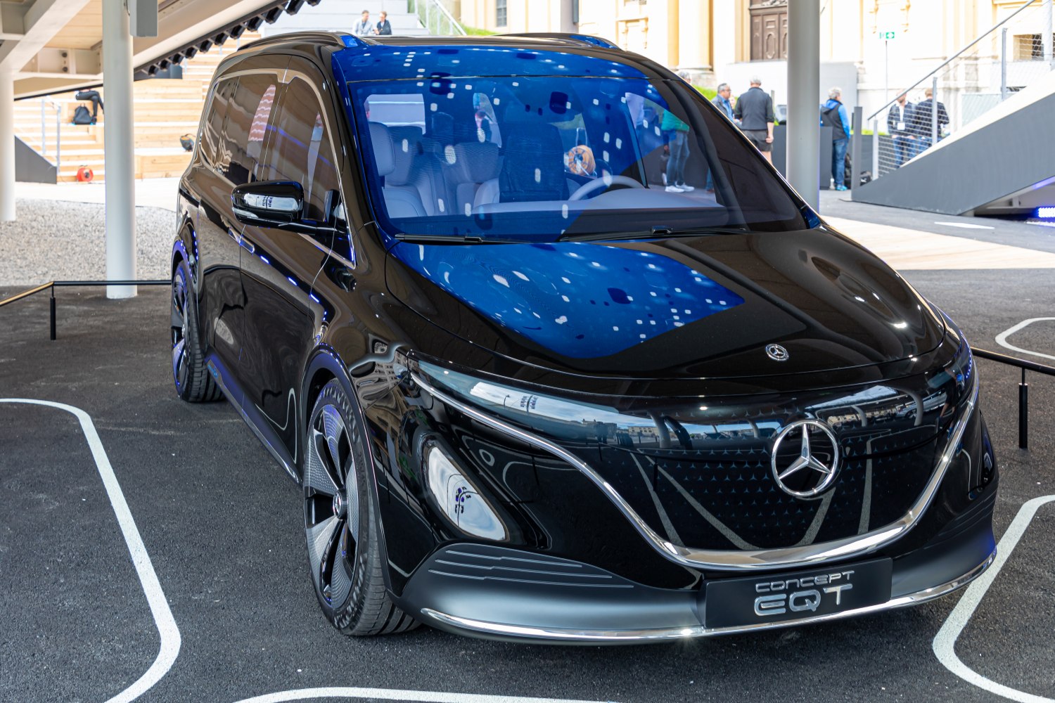 Futuristic electric van front with aerodynamic design and sleek headlights