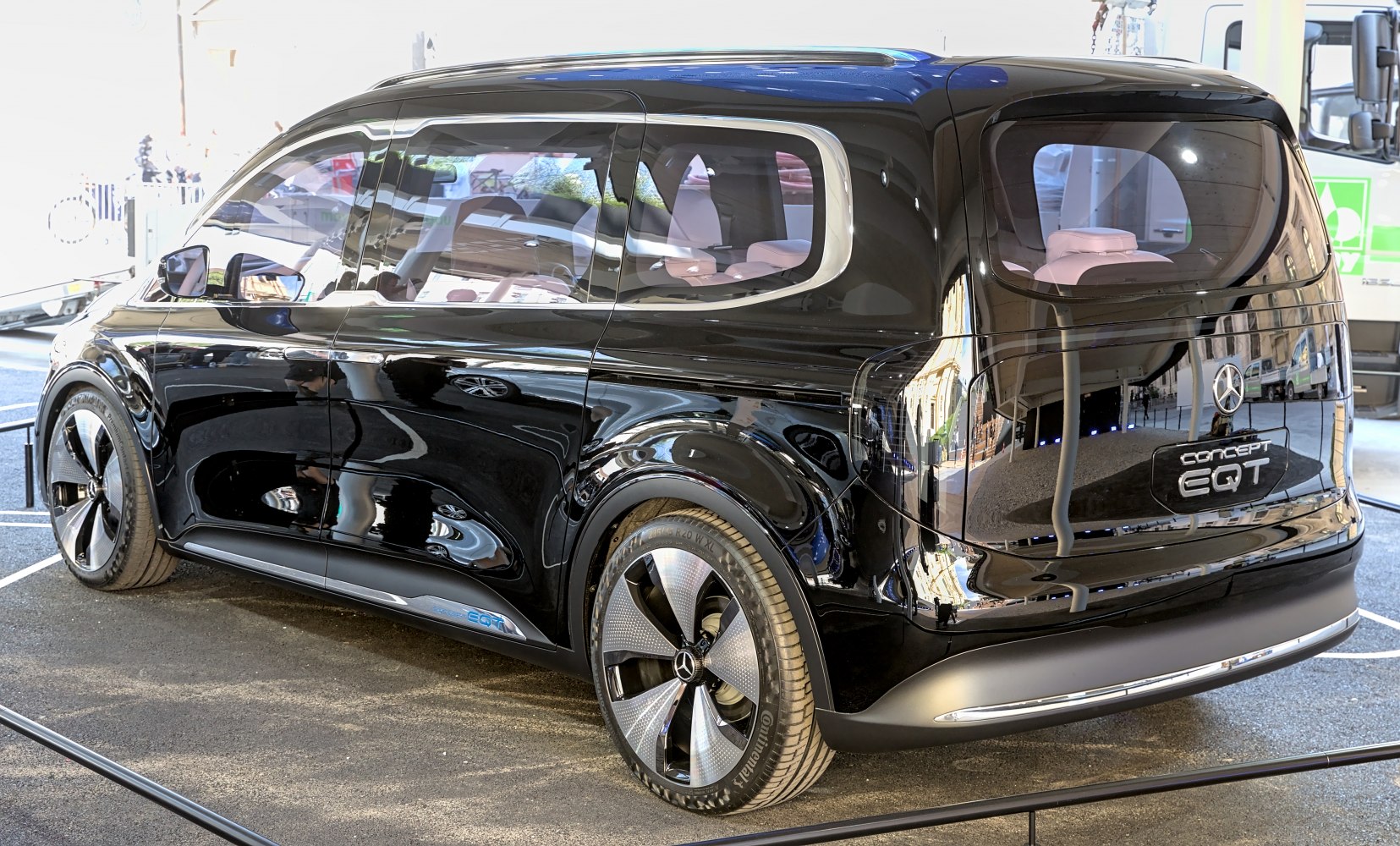 Black electric MPV with unique alloy wheels, rear and side view
