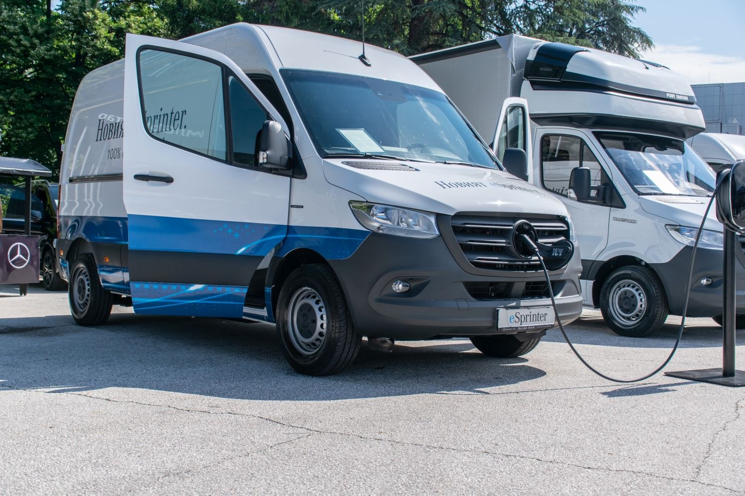Electric panel van plugged into charging station