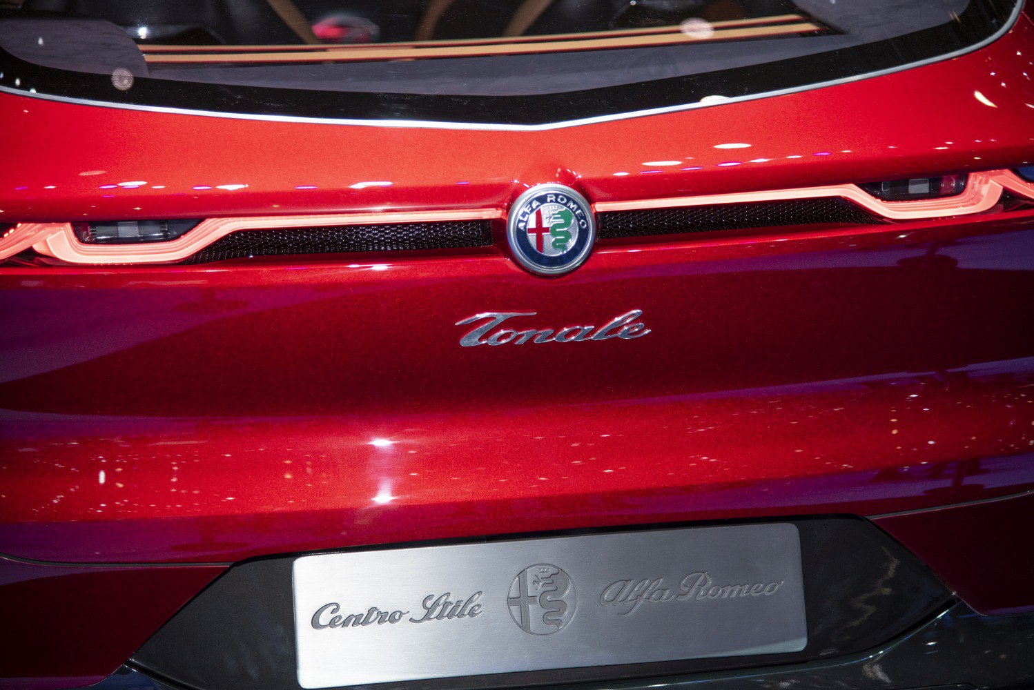 Rear emblem and tail light design of a red car