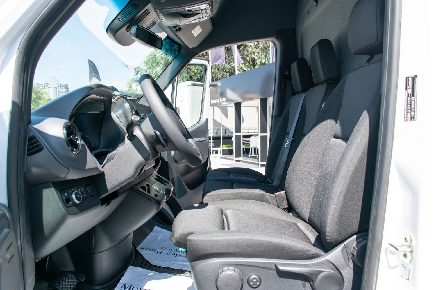 Front seats and dashboard interior of a commercial panel van