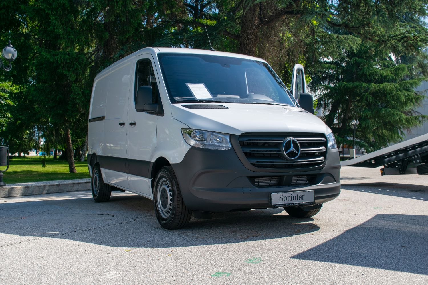 Front view of a white panel van with distinctive grille and headlights