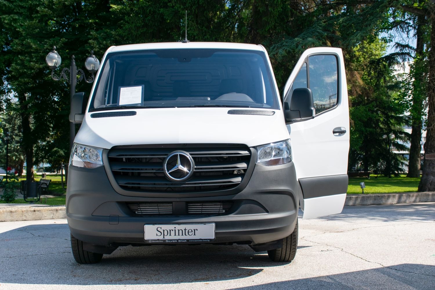 Front view of a panel van with open driver's door
