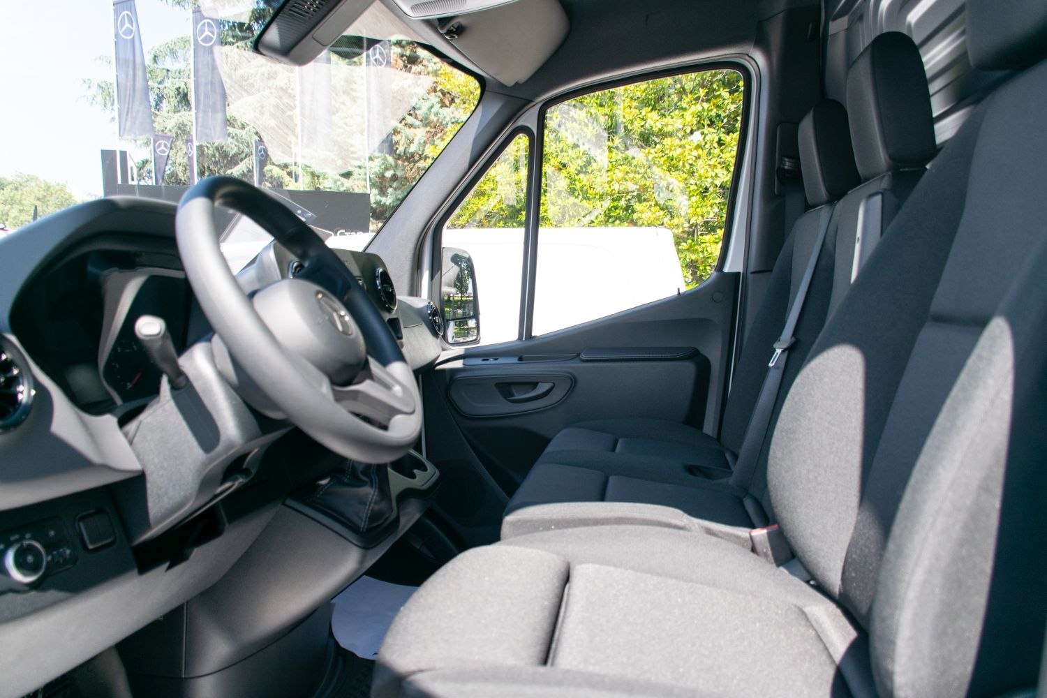 Front cabin interior with steering wheel and seating row