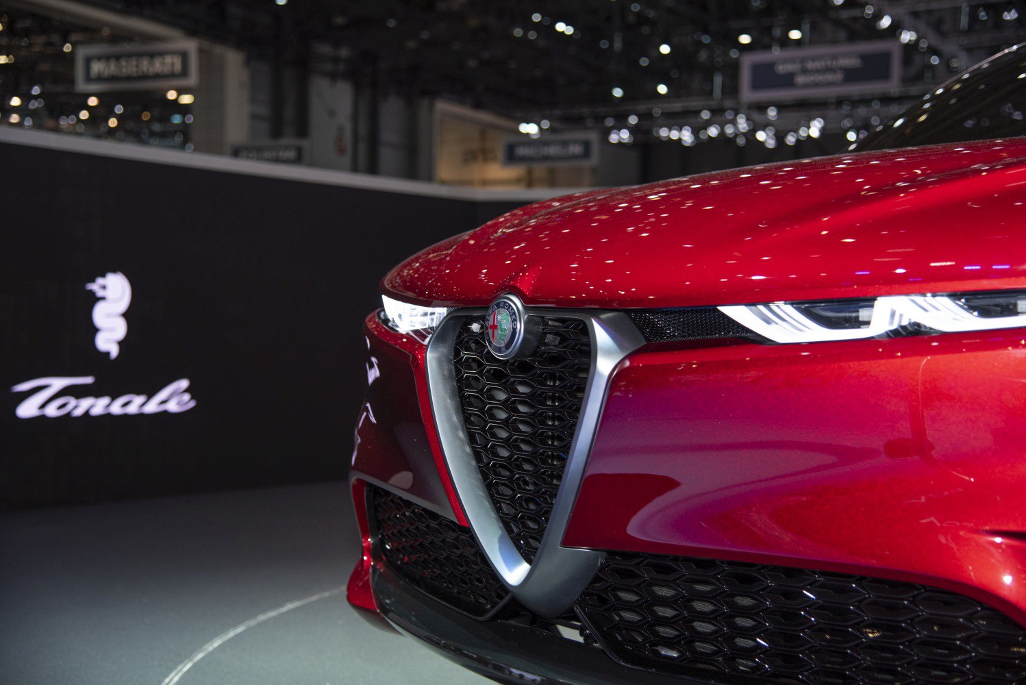 Close-up of front grille with Alfa Romeo emblem and sleek LED headlights