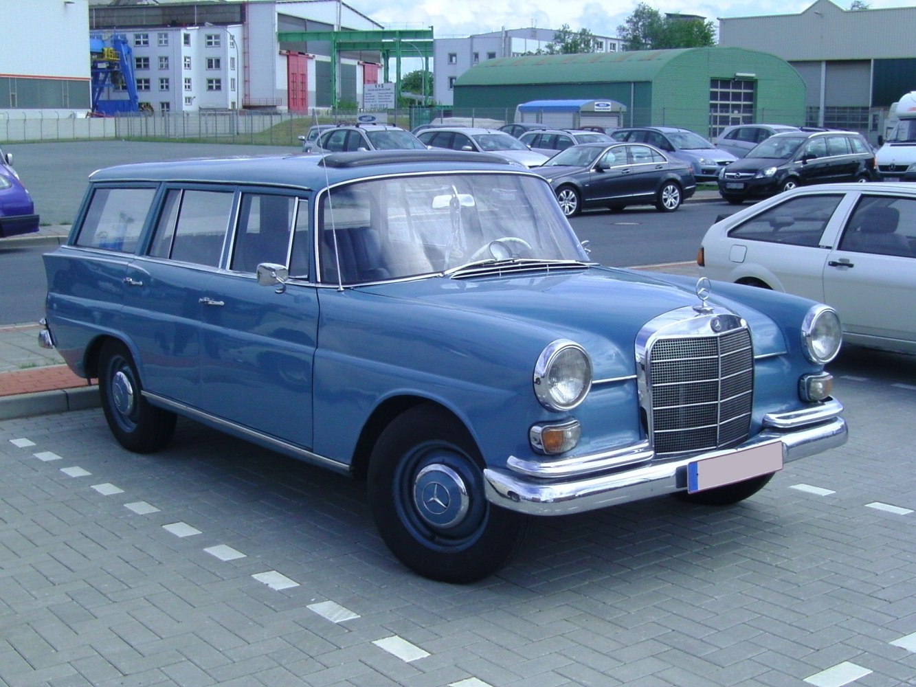 Classic vintage station wagon with round headlights and chrome grille