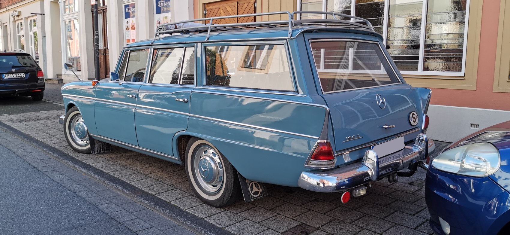 1960s vintage station wagon with roof rack and chrome bumpers