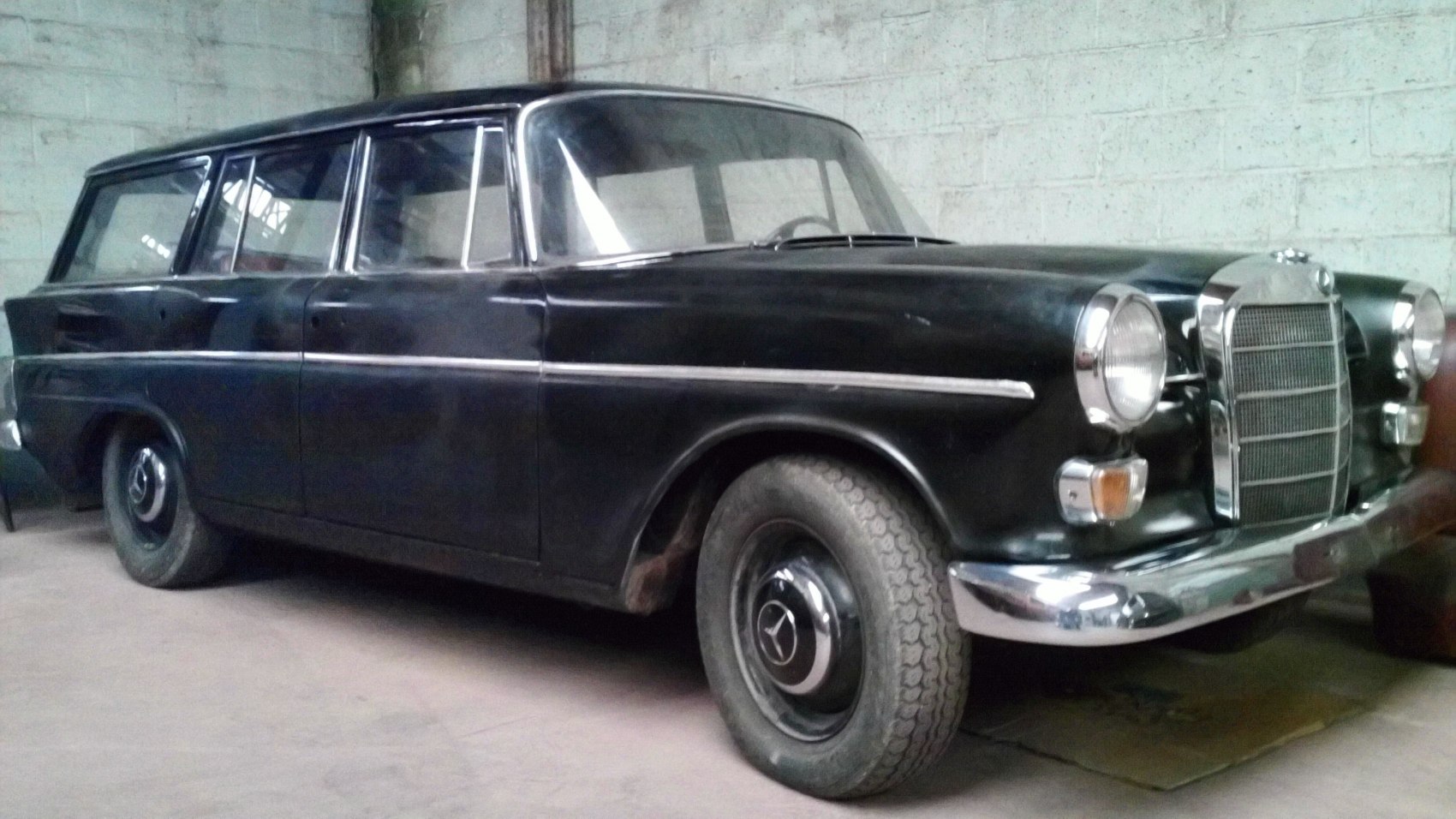 Large vintage station wagon with classic grille and round headlights.
