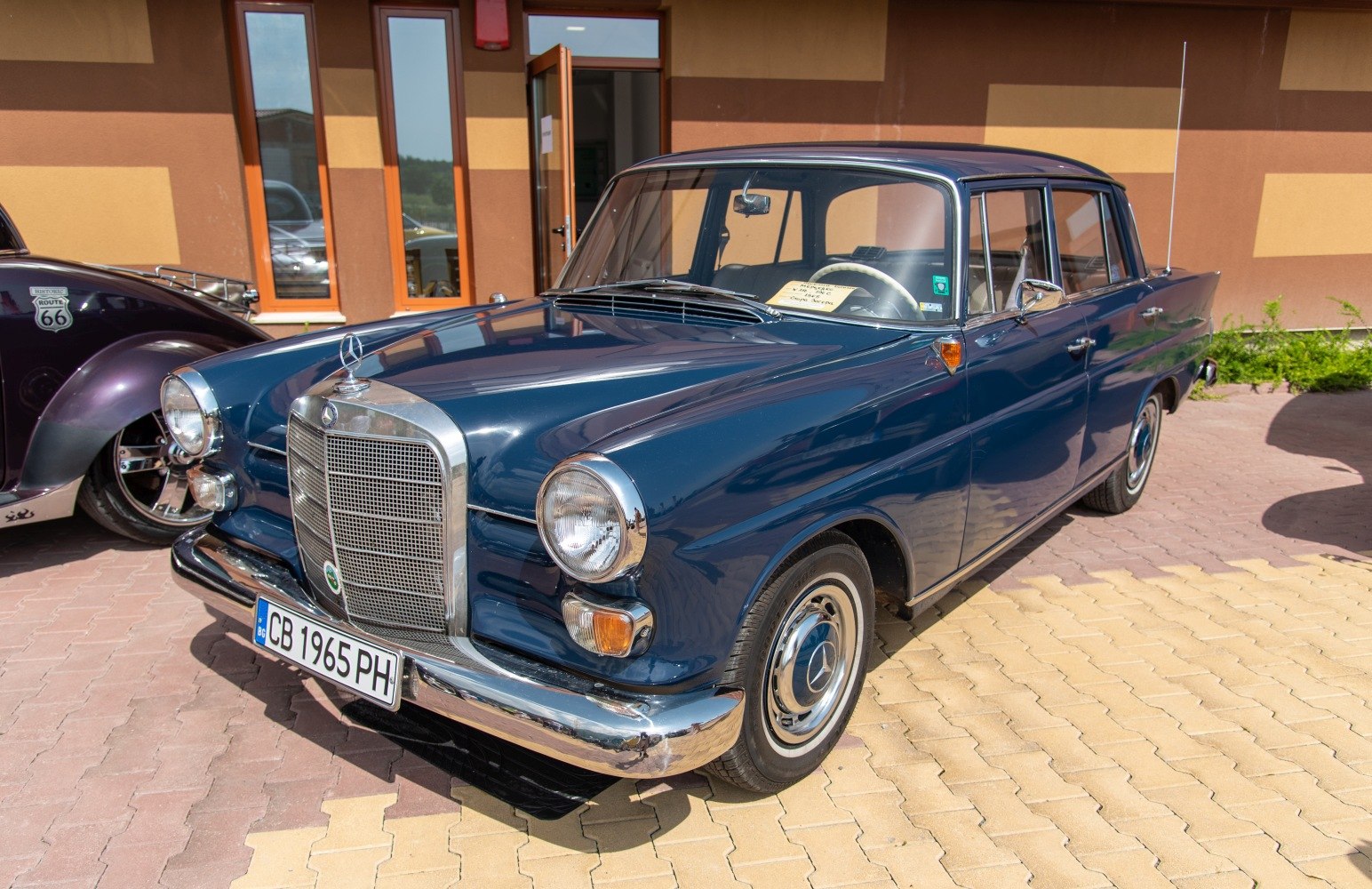 Classic vintage car front with prominent grille and rounded headlights