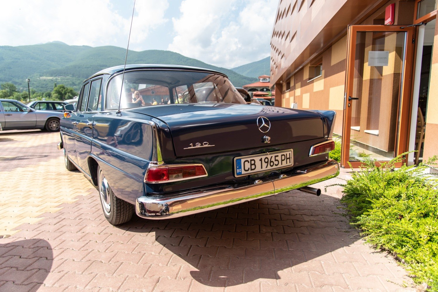 Vintage sedan rear with distinctive tail fins and chrome bumper