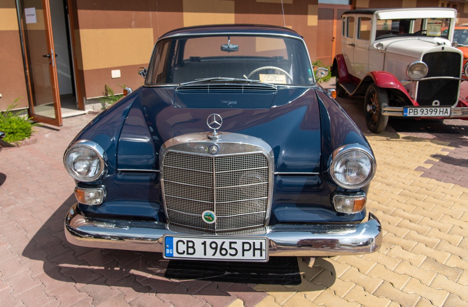 Front close-up showing classic grille and round headlights of vintage vehicle from 1960s