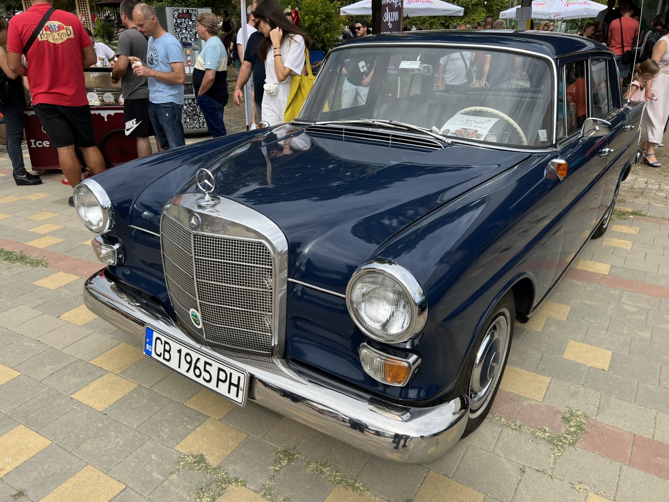 Vintage sedan with chrome grille and large round headlights