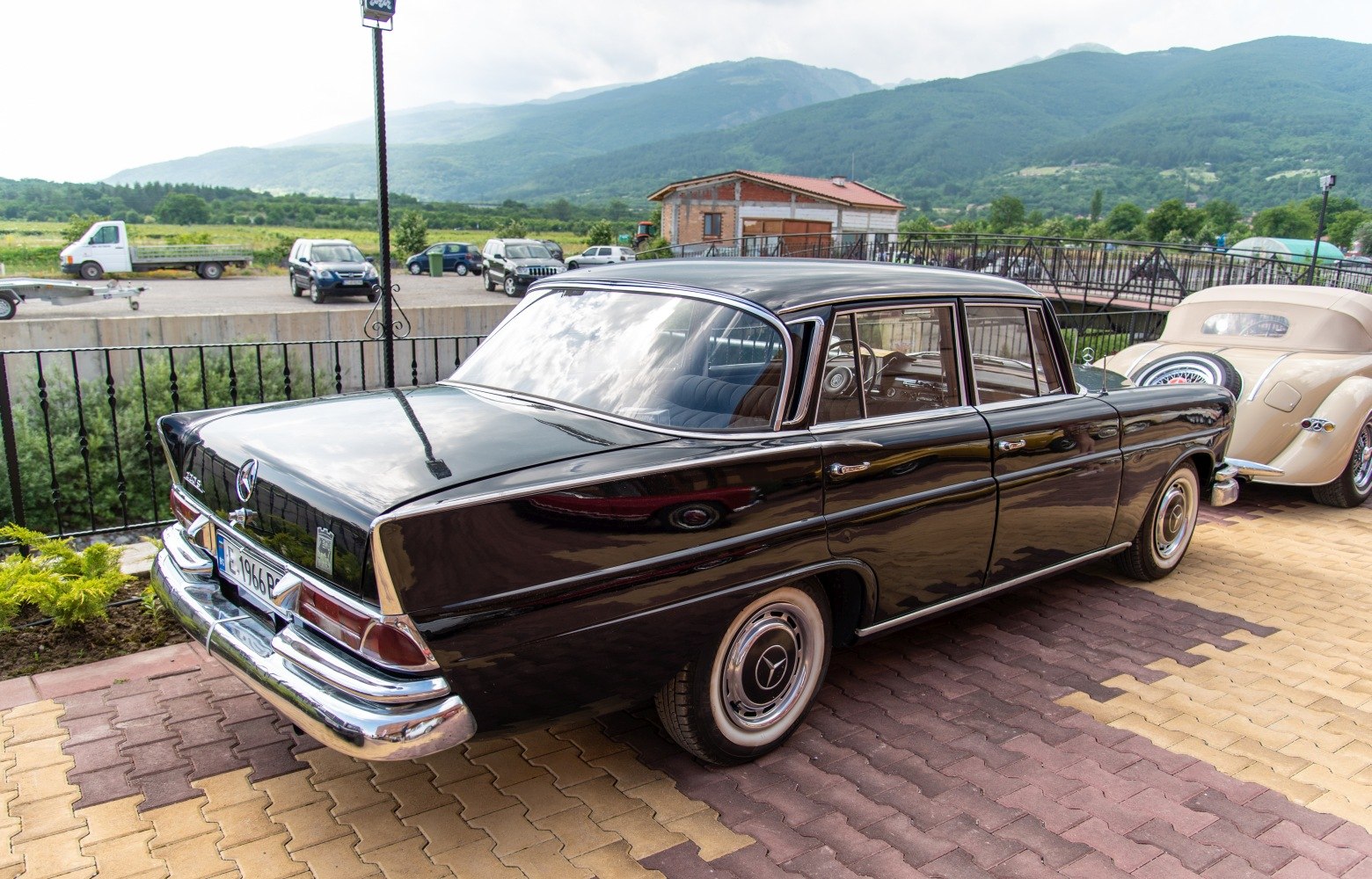 Black vintage sedan with tailfin and chrome bumpers