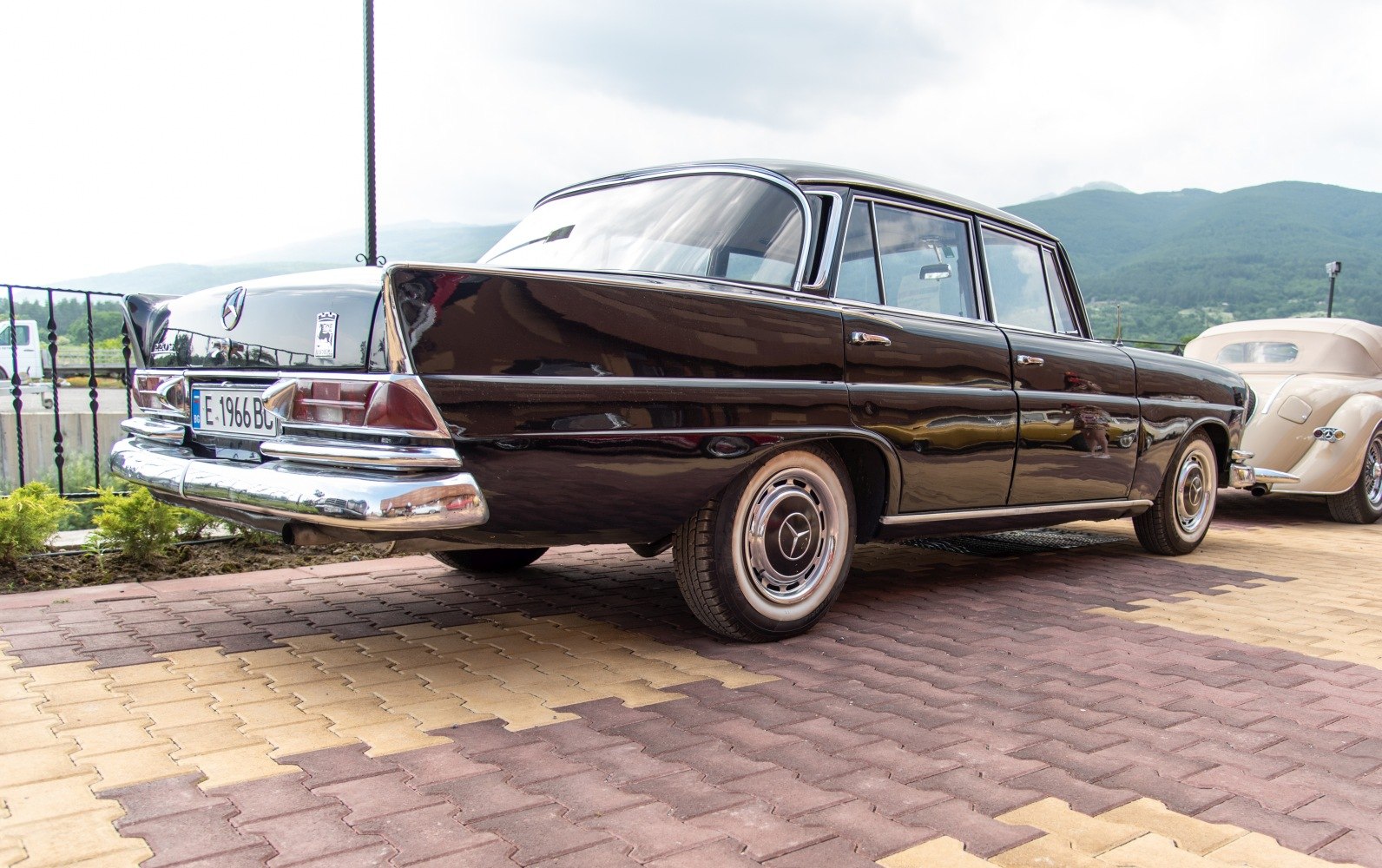 Classic vintage sedan displaying chrome bumper and distinctive tail fins.