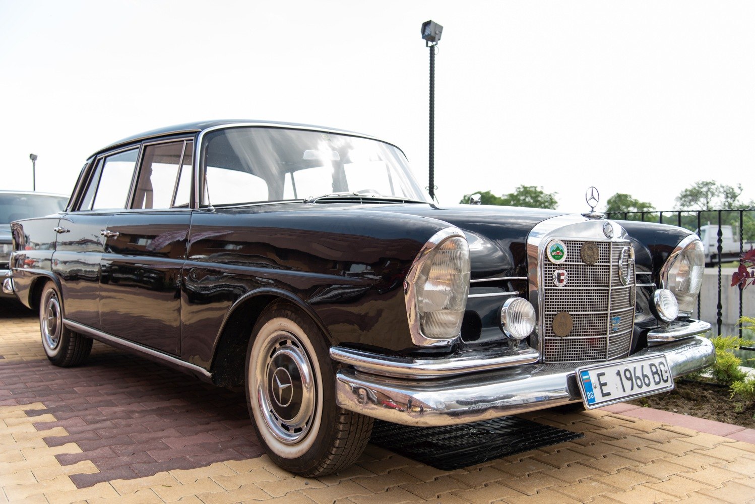 Vintage sedan front with retro headlights and chrome grille