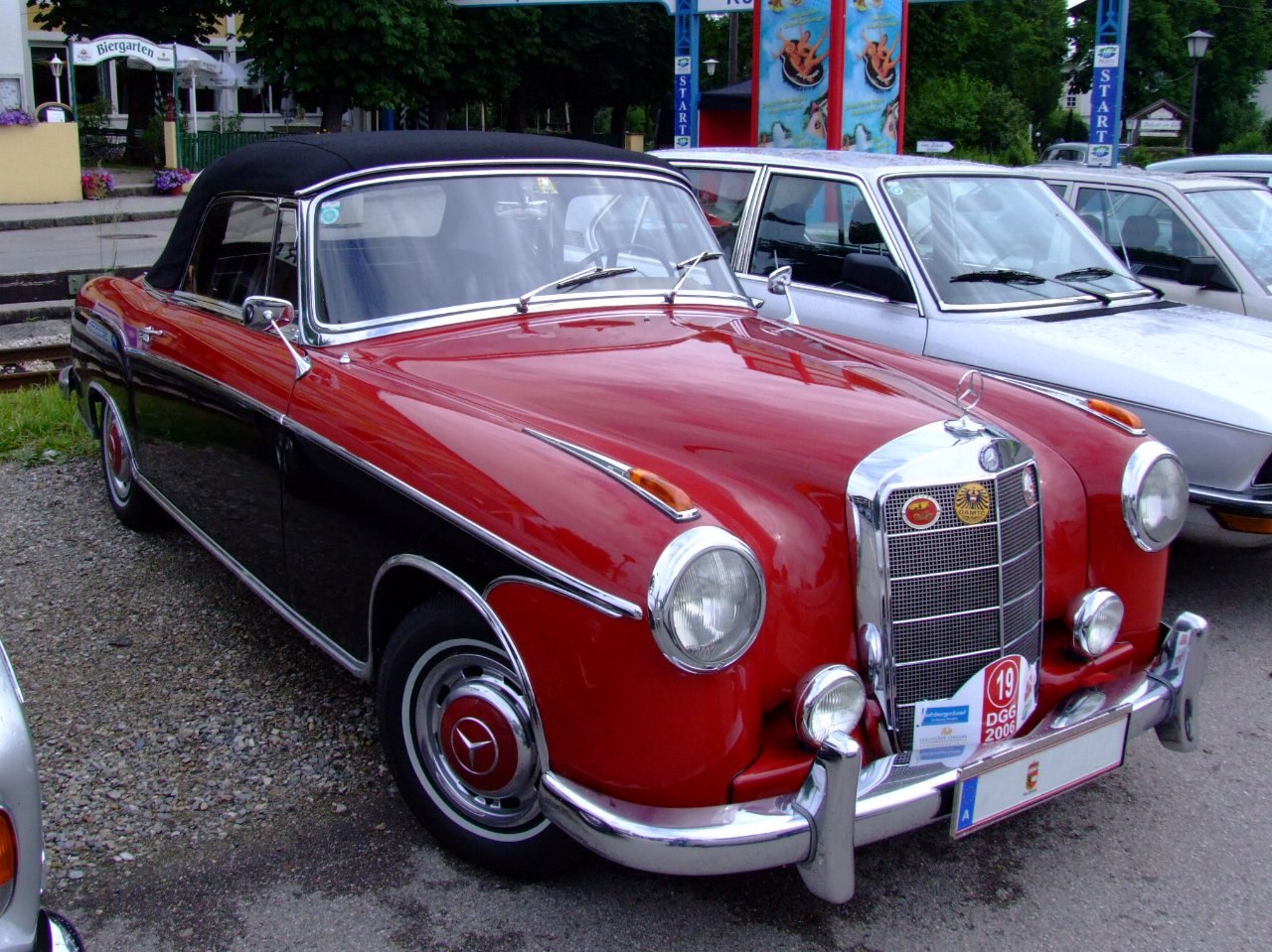 Two-tone vintage convertible with chrome grille and classic round headlights