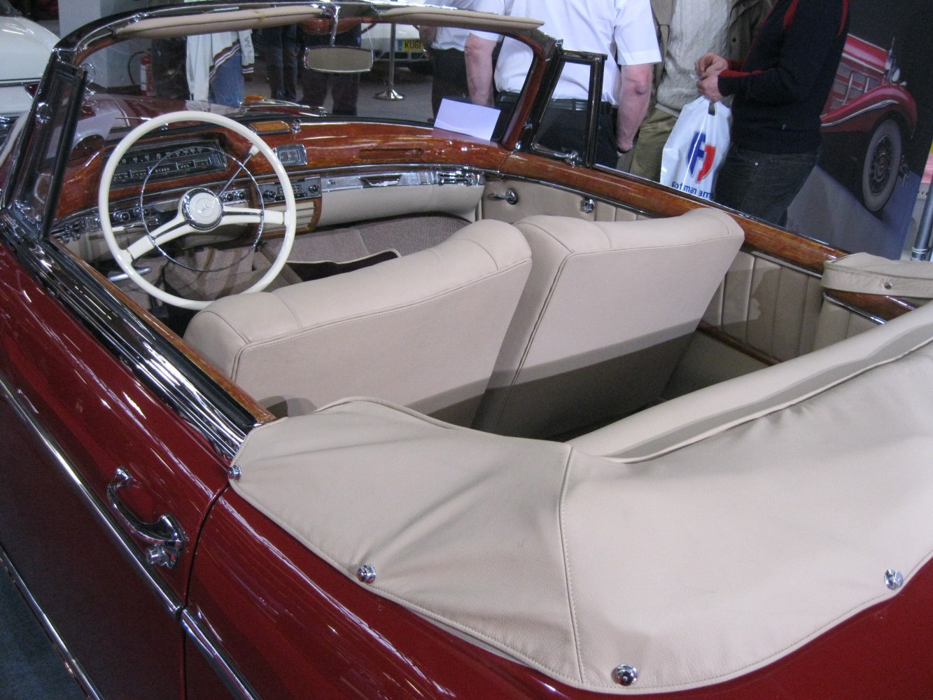 Classic convertible interior with wooden dashboard and beige leather seats