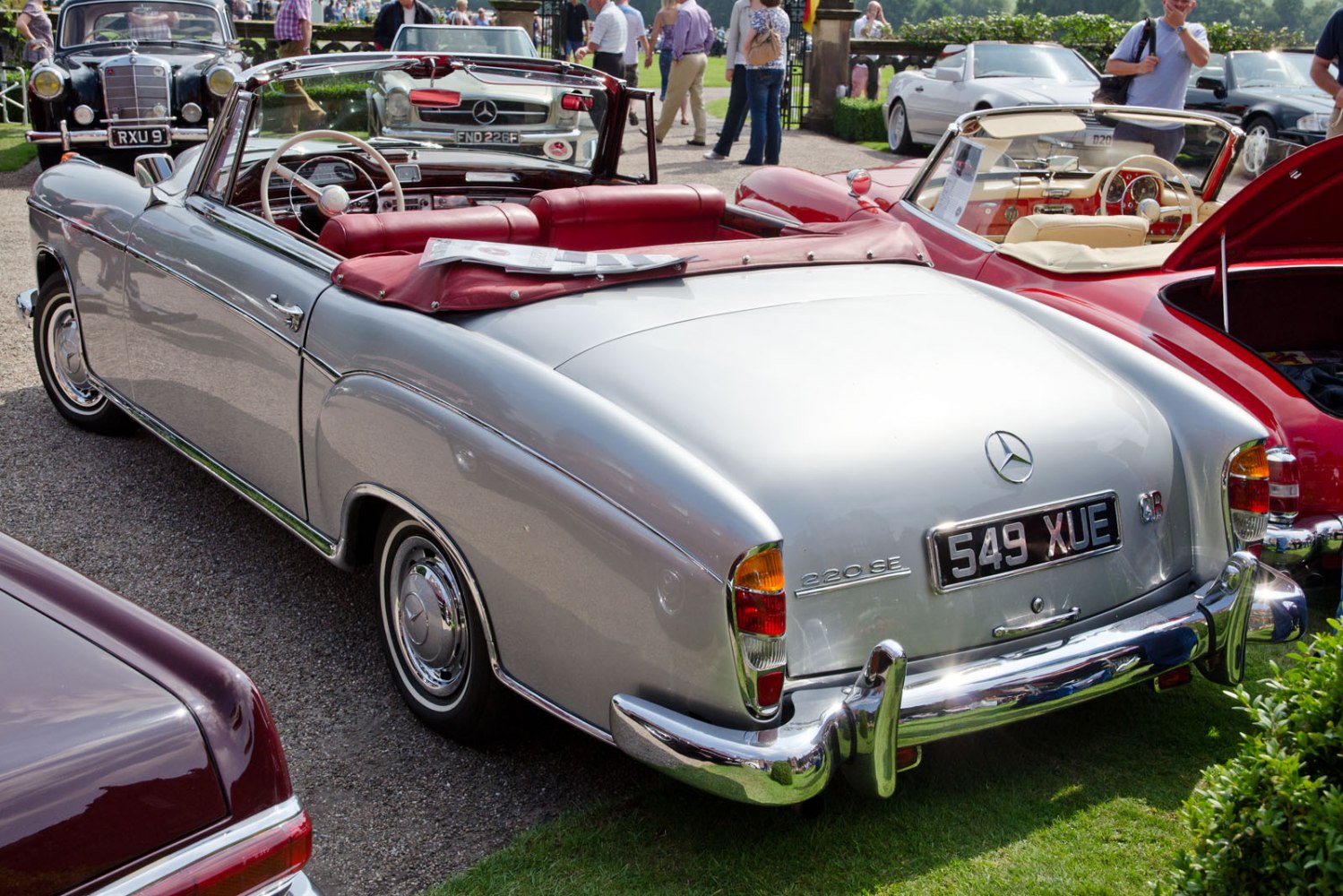 Silver convertible with red leather interior and chrome bumper