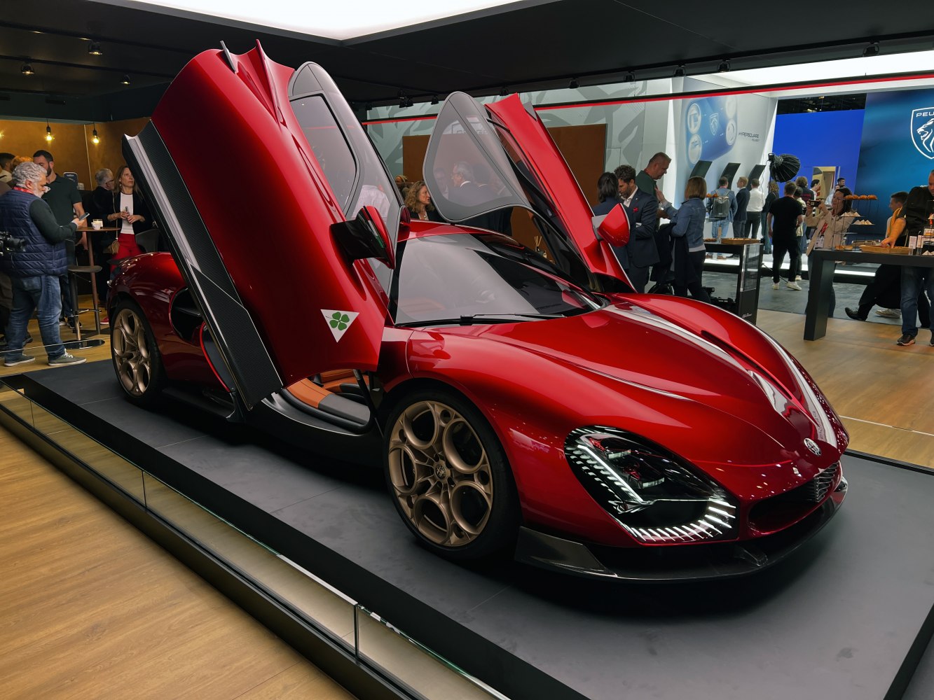 Red sports car with distinctive scissor doors and futuristic LED headlights