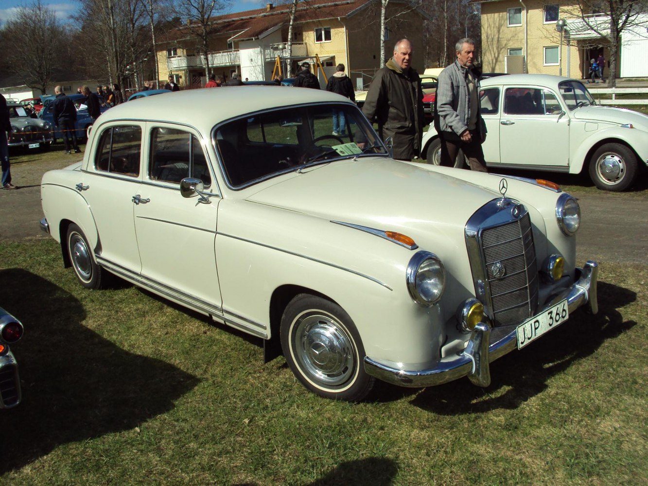 Vintage sedan with chrome grille, round headlights, classic 1950s styling