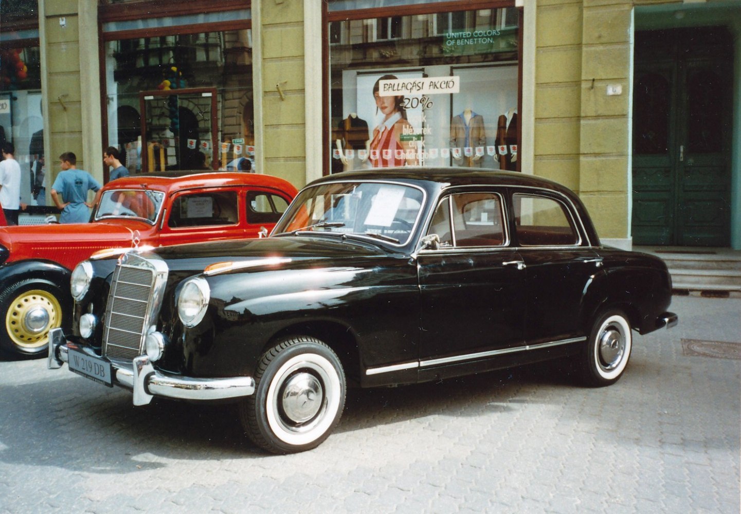 Black vintage sedan with chrome grille and whitewall tires