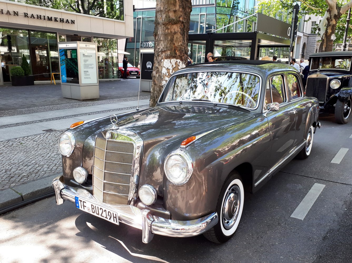 Front angled view of vintage sedan with round headlights and chrome grille.