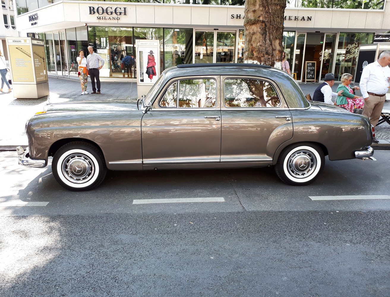 Vintage sedan side view with whitewall tires and chrome hubcaps