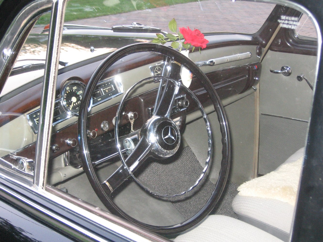 Vintage steering wheel and dashboard with classic mid-century gauges and controls