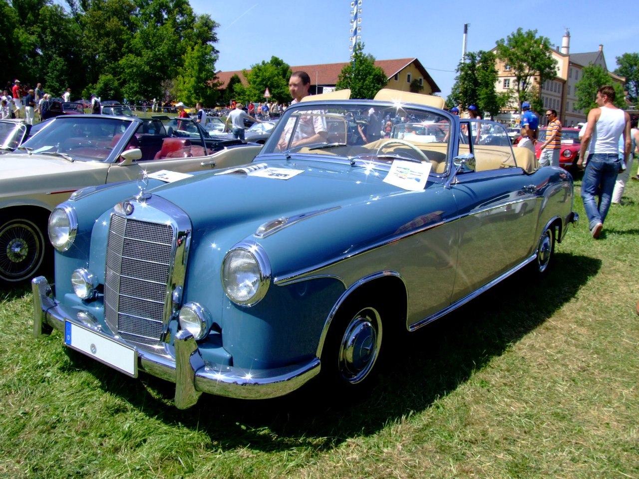 Vintage convertible with chrome grille and round dual headlights