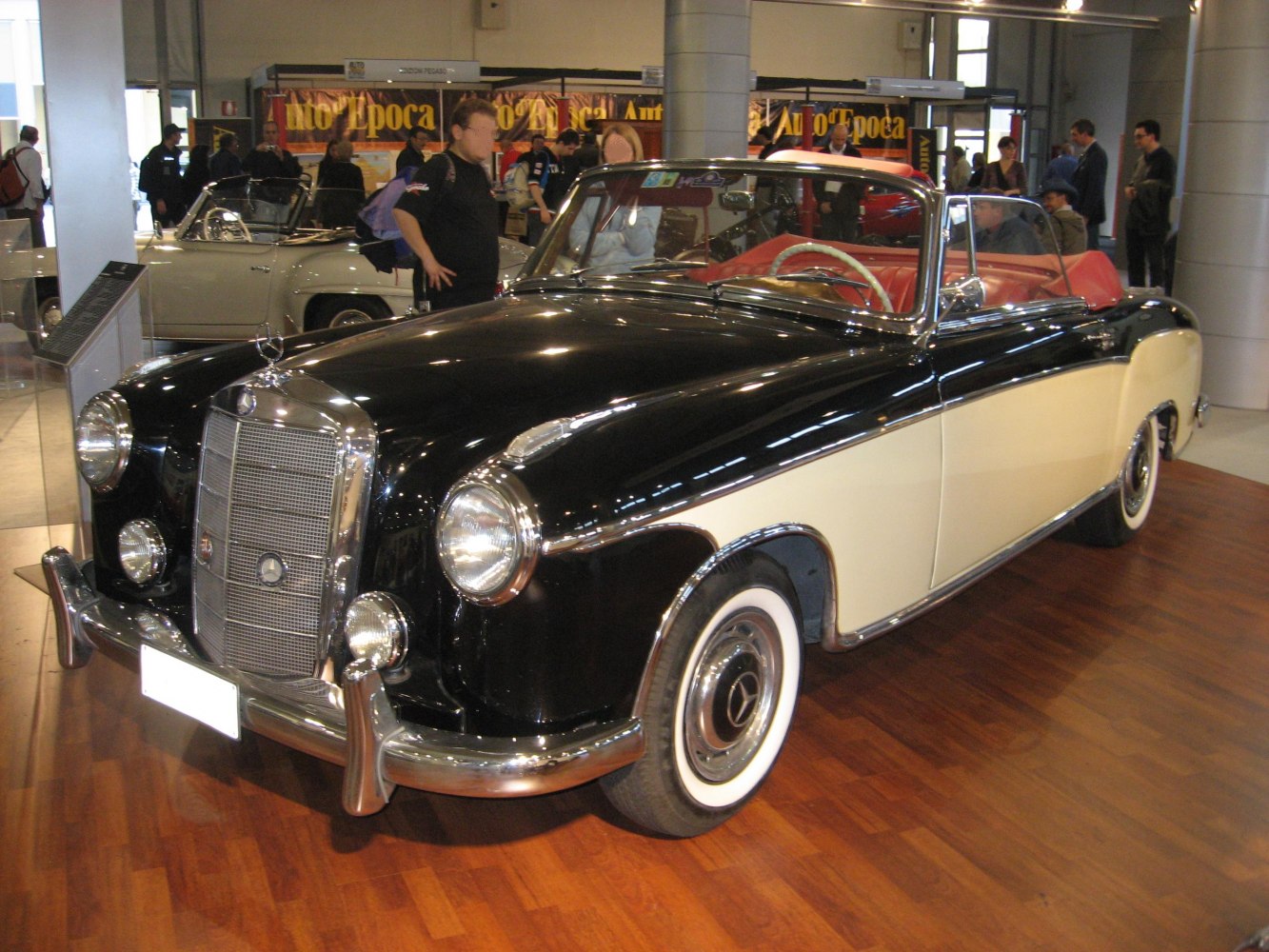 Two-tone vintage convertible with chrome grille and whitewall tires