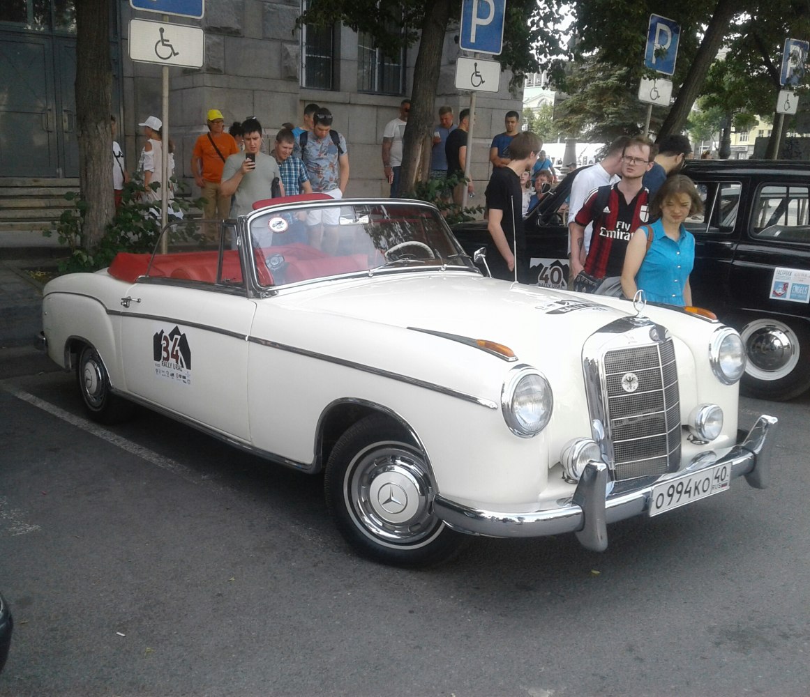 Vintage convertible with chrome grill and red interior